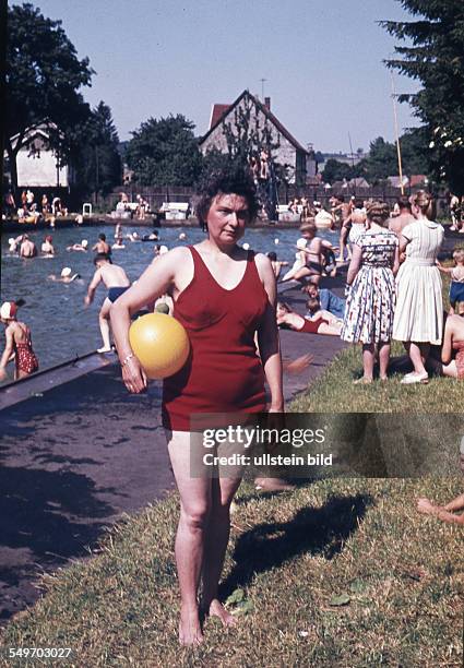 Adult in an open air pool - 1950s