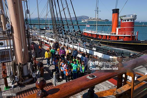 School kids visiting historic sailing ship Balclutha in San Francisco Maritime National Historical Park in San Francisco California USA