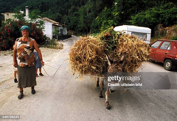 Greece, Ionian Isalnds, Corfu Island, farmer's wife with mule