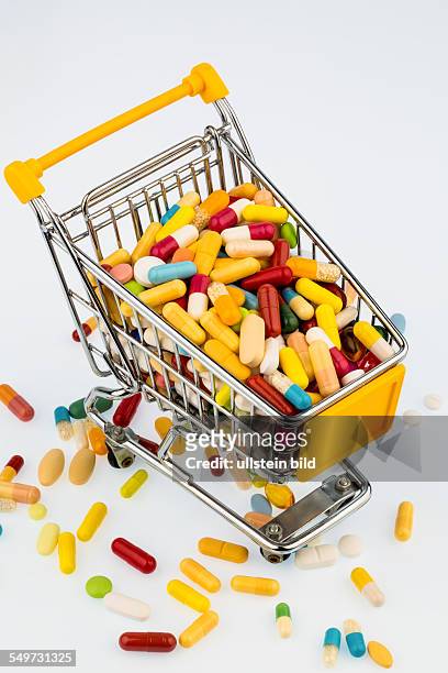 Bunte Tabletten im Einkaufswagen, Symbolfoto für Gesundheitskosten, Apotheken, Fülle an Medikamenten
