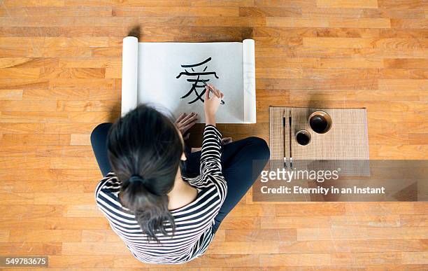 artist painting chinese calligraphy - chinese symbols stock pictures, royalty-free photos & images