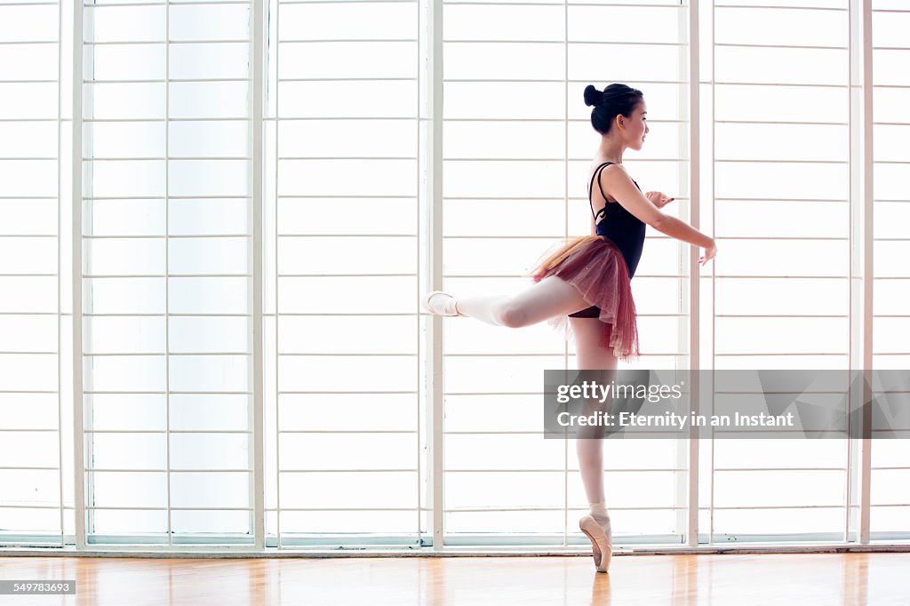 Ballerina dancing in studio
