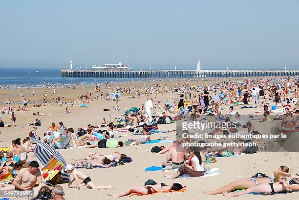 crowd on the ostend beach in may - oostende stockfoto's en -beelden