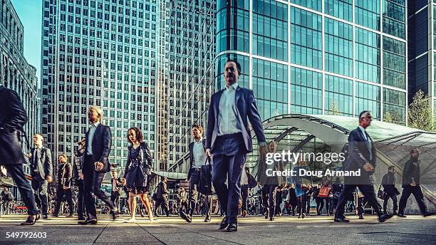 commuters exiting canary wharf station - rush hour stock pictures, royalty-free photos & images