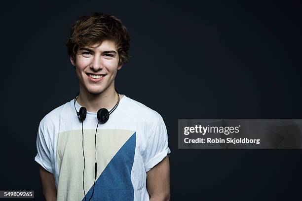 portrait of young man with headphones smiling - 19 years stock pictures, royalty-free photos & images