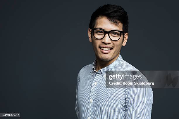 portrait of creative man with glasses smiling - striped shirt stockfoto's en -beelden