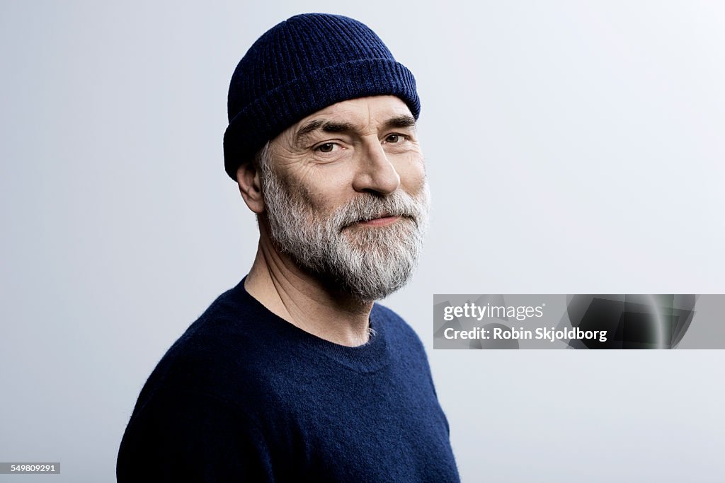Portait of grey haired man wearing hat