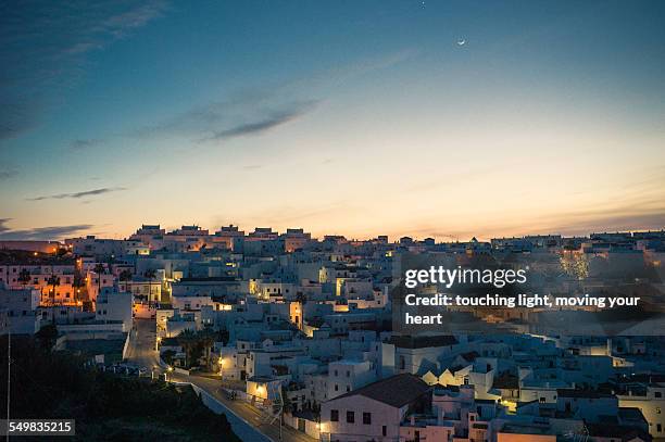 dusk of a spanish hilltop white town in andalucia - vejer de la frontera stockfoto's en -beelden
