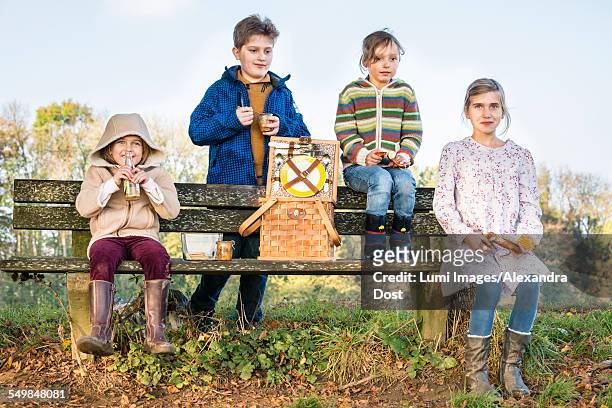 children having picnic outdoors - alexandra dost stock-fotos und bilder