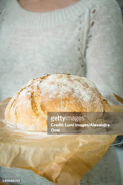 person holding fresh bread - alexandra dost stock-fotos und bilder