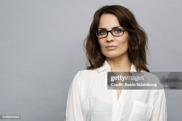 portrait of woman with glasses in white shirt - white woman brown hair stock pictures, royalty-free photos & images