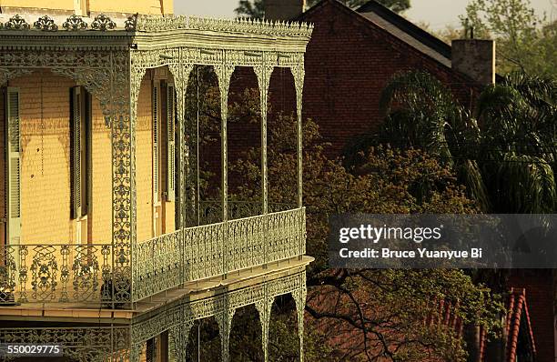 house with wrought iron balcony - new orleans french quarter stock pictures, royalty-free photos & images