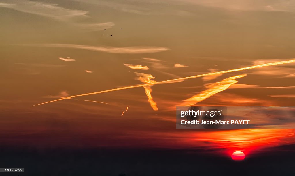 Dramatic sky at sunrise with birds silhouettes