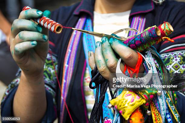 black hmong woman's hand - marineblauw stock-fotos und bilder