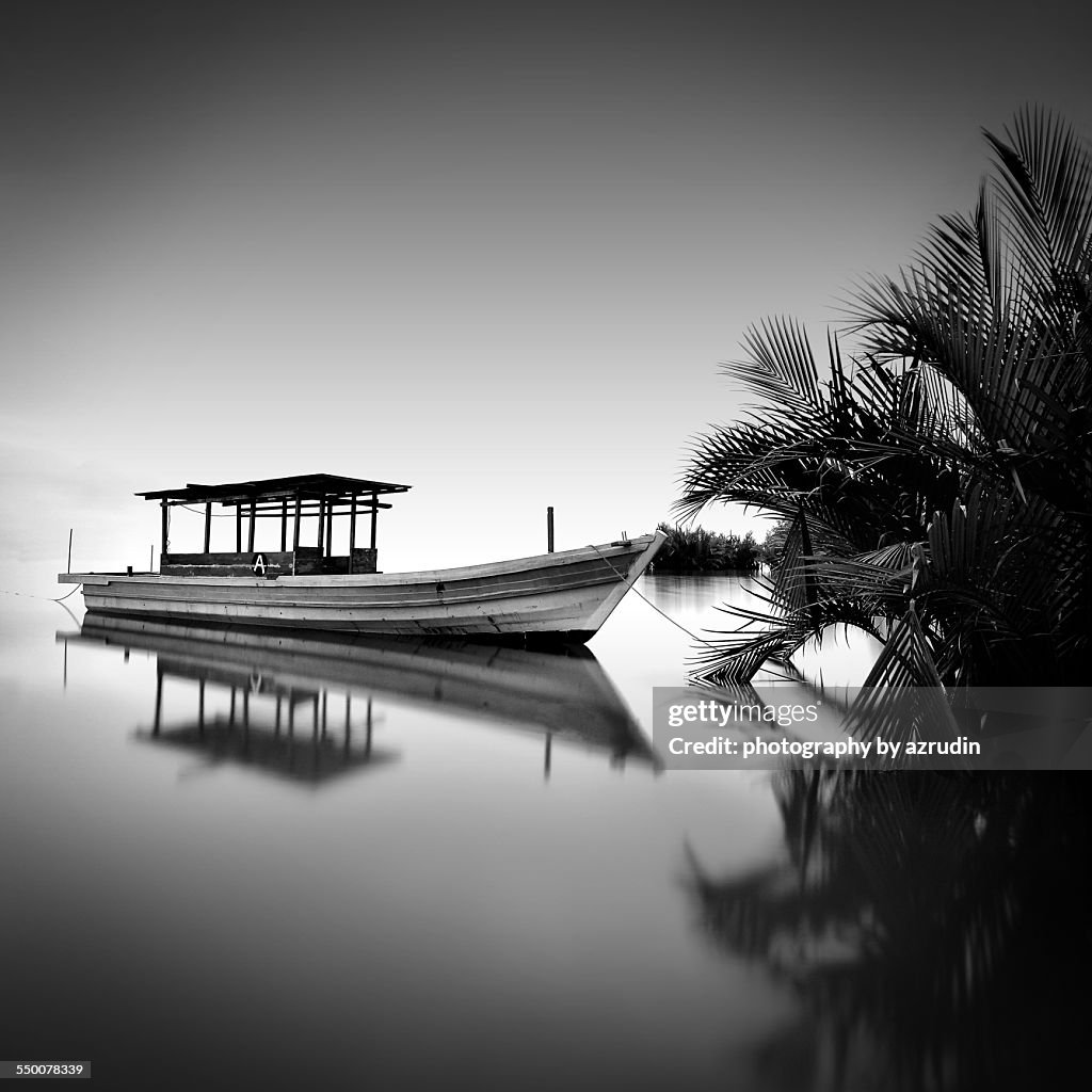 Boat in calm water in black and white