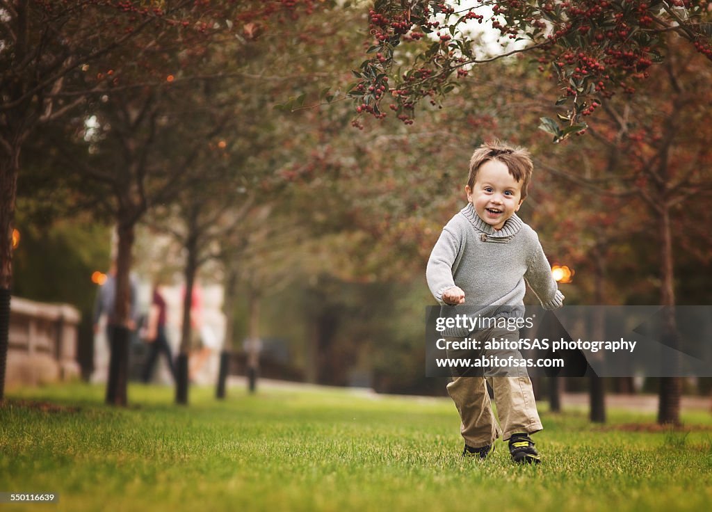 Toddler boy running in park