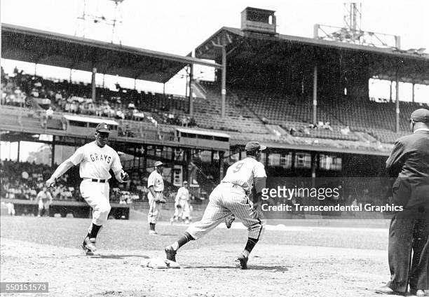 Action photographic print taken during a Negro League game between the home team Homestead Grays versus the New York Black Yankees at Griffith...