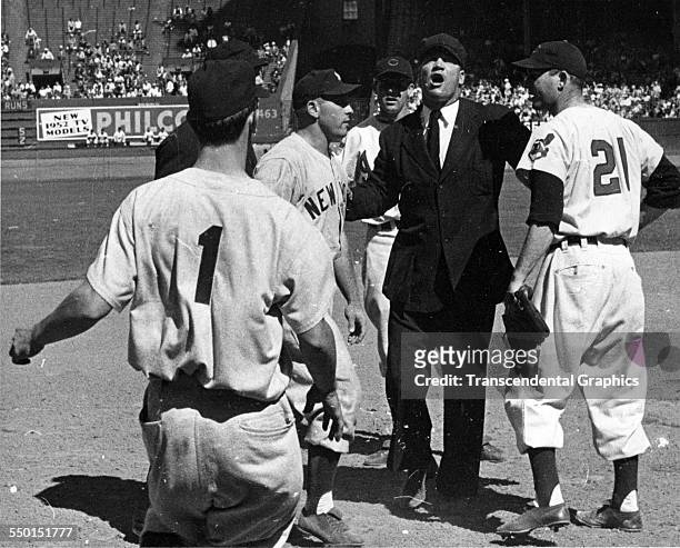 This wire photograph from Municipal Stadium shows umpire Hank Soar breaking up a fight between the Cleveland Indians and New York Yankees, Cleveland,...