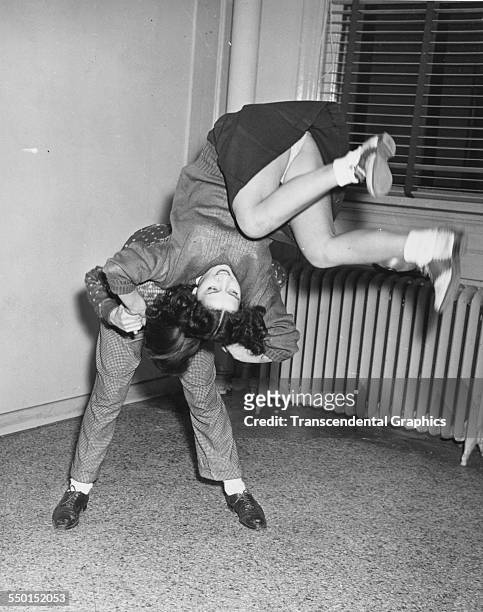 Publicity photograph, by the Scotty Bjurstrom Agency, showing wild teenage dancing, the latest craze, Chicago, Illinois, circa 1950.