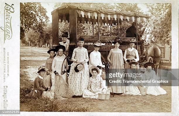 Cabinet photograph, by Beverege, of a group of young women out for a trip in a horse-drawn surrey, Marshalltown, Iowa, circa 1885.
