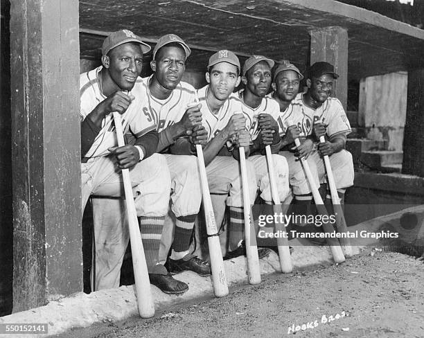 Photographic print by the Hook Brothers of a group of Cuban baseball players from the Negro League Red Sox in the dugout together during a home game,...