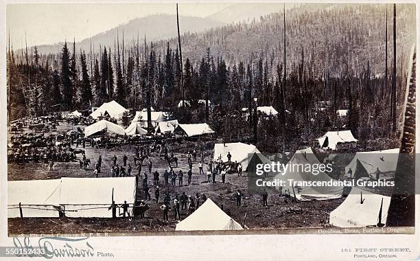 Cabinet photograph, by JG Davidson, with a camp scene from the construction of the Northern Pacific Railroad, Washington, circa 1880.