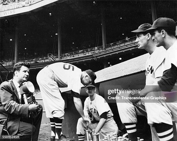 Osvaldo Salas, far left, photographer for El Diario sizes up Ted Williams, second from right, for a photograph before a game at Fenway Park, Boston,...