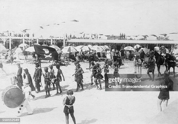 Young revelers dressed as pirates pause for a group portrait after their parade, Coney Island, New York, New York, circa 1900.