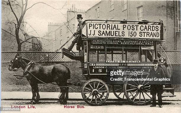 Postcard shows JJ Samuels as he puts his sign on a British horse bus, London, England, circa 1910.