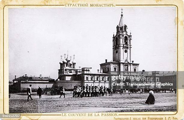 Cabinet photograph from a series, by Heppensberger of Riga, features marching guards in front of the Convent of the Passion, Moscow, Russia, circa...