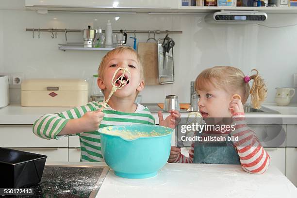 Family Scene: A little boy and a little girl baking a cake together. Aachen