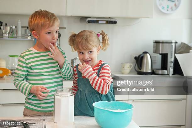 Family Scene: A little boy and a little girl baking a cake together. Aachen