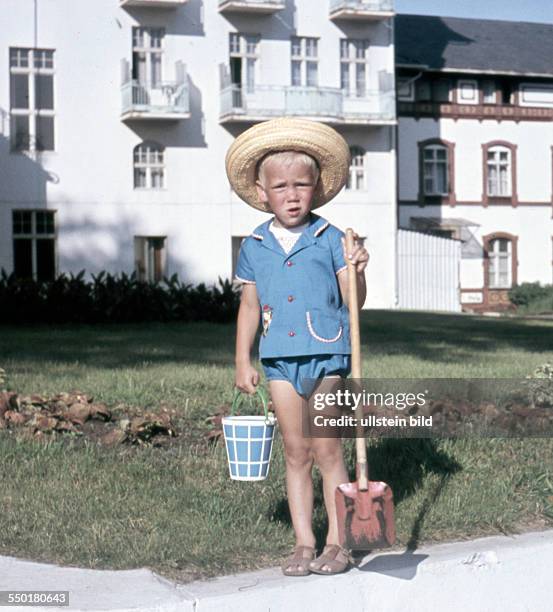 East Germany, summer at the seaside: little boy with a bucket and a shovel