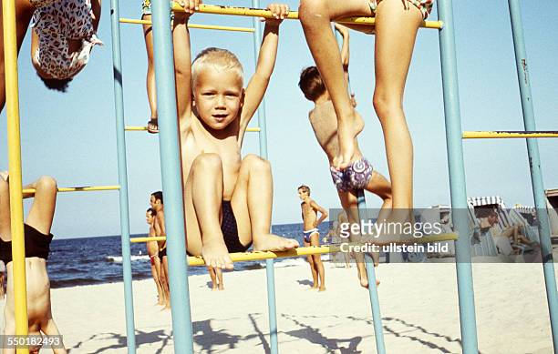 Summer at the Seaside: child on climbing frame on a beach at the Baltic Sea