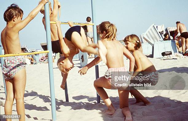 Summer at the Seaside: children on climbing frame on a beach at the Baltic Sea