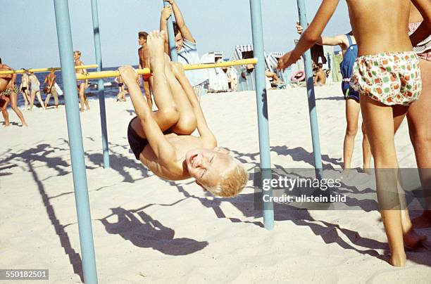 Summer at the Seaside: child on climbing frame on a beach at the Baltic Sea