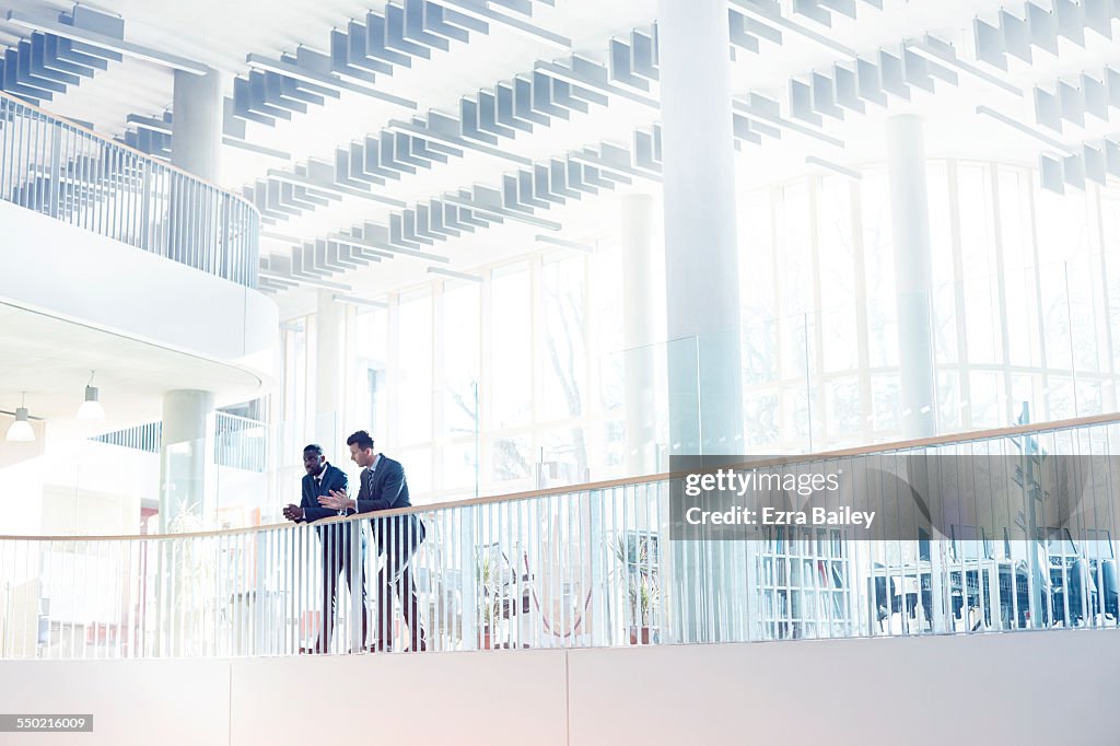 Businessmen discussing plans in modern office