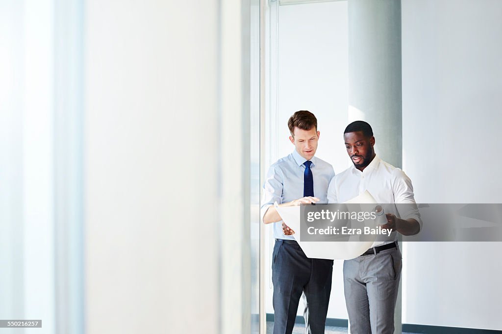 Two businessmen looking at plans