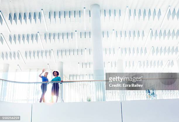 businesswomen discussing ideas in open plan office - abstract ideas stock pictures, royalty-free photos & images