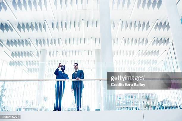businessmen discussing ideas in open plan office - 建築上の特徴 ストックフォトと画像