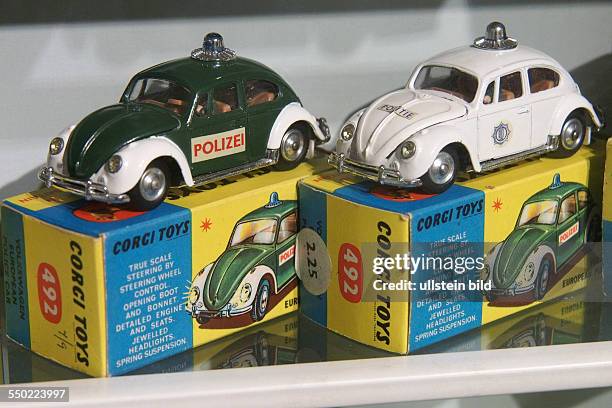 Green and white Volkswagen VW European police cars from Corgi Toys plus box, Toy and model museum, Brighton, East Sussex, England, UK, on
