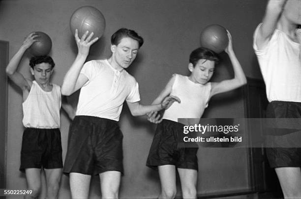 Physical education lesson, children practising in the gym