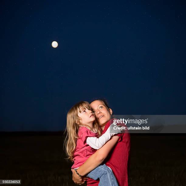 Mother, 32 years, with daughter, 4 years, looking at the stars.