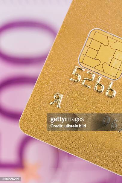 Eine Goldene Kreditkarte zum Bargeldlosen Bezahlen mit einem Euroschein