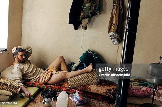 April 26 Yabrud, Rif Dimashq, Syria. An FSA fighter is resting inside a secret location after being shot in the legs during clashes against...