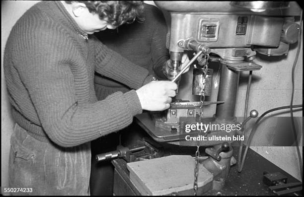 Adolescents working in the metalworking shop