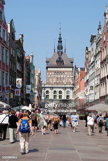 Tourists in front of the Golden Gate in the Long Street from Gdansk.