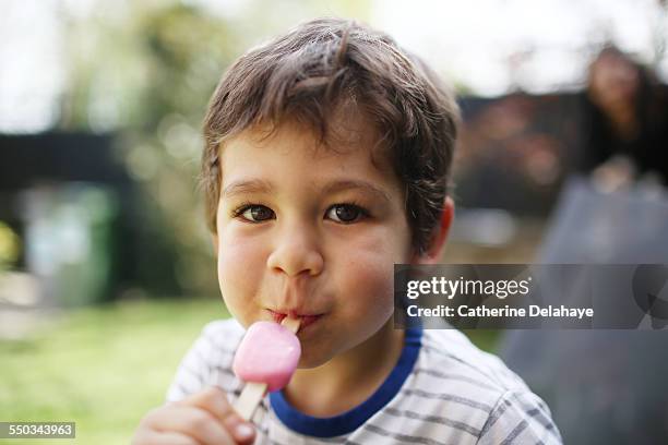 a 3 years old boy eating a ice cream - 2 3 years stockfoto's en -beelden