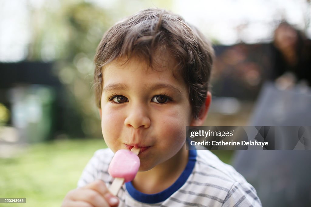 A 3 years old boy eating a ice cream