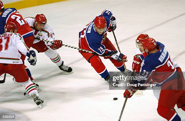 Alexei Yashin of Russia prepares to throw a backhanded shot at the net during the Salt Lake City Winter Olympic Games at the E Center in Salt Lake...